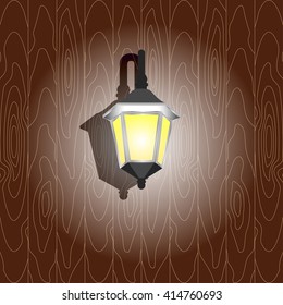 Wall light on the wooden wall. Isolated.