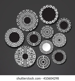 Wall with plates. The background plates on the wall. Isolated dish. Black plate with ethnic ornament in the African style on a white background