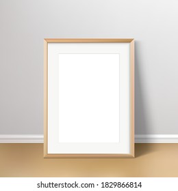 Wall poster realistic mockup. Wooden frame standing on the floor with passepartou mock up. Vector illustration.