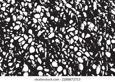 The wall of stones is laid out in a mosaic. Black and white shades