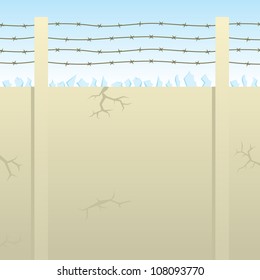 Wall (with cracks here and there) equipped with glass shards and barbed wire to discourage would-be intruders.