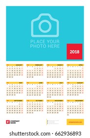 Wall yearly calendar poster for 2018 year. Vector design print template with place for photo. Week starts on Monday. 12 months on page. Stationery design