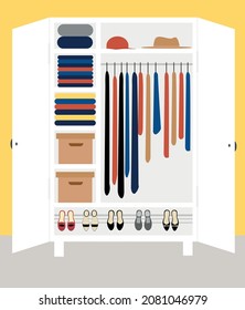 A wardrobe full of things. Open wardrobe. Dresses in the closet. Shoes in the closet. Hats and boxes in the closet