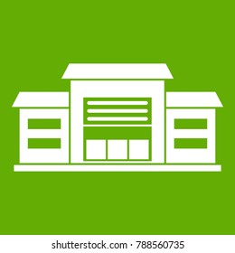 Warehouse icon white isolated on green background. Vector illustration