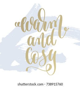 warm and cozy hand lettering holiday poster on light blue brush stroke background, christmas winter quote, calligraphy vector illustration