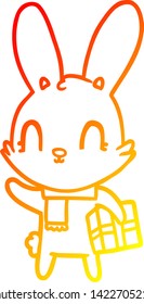 warm gradient line drawing of a cute cartoon rabbit with christmas present