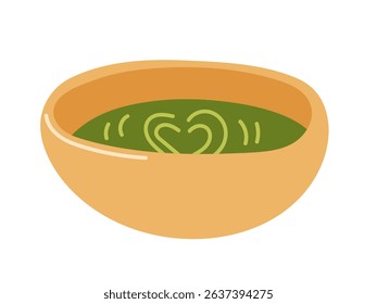 Warm green soup in a bowl with heart design on top