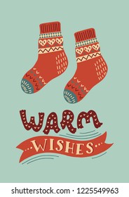 Warm knitted socks with lettering "Warm wishes". Vintage card or poster. Hand drawn vector illustration with hand lettering.