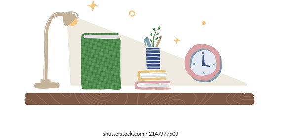 luz cálida con libro y reloj en el escritorio