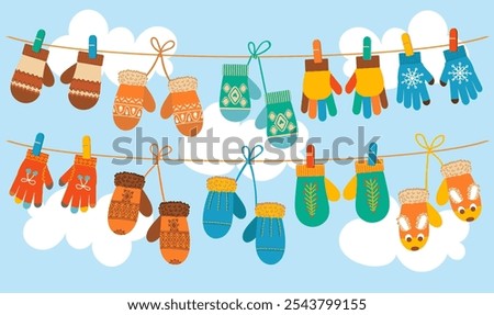 Warm mittens hang on rope. Knitted gloves are drying. Winter clothes. Woolen patterned things. Warming accessories. Clothing hanging on clothesline with clothespins