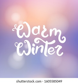 Warm winter title. Brush lettering at blurred winter background with bokeh lights. Vector card design with handwritten calligraphy