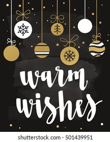 Warm Wishes. Holiday greeting with calligraphy and decorative elements. Handwritten modern lettering with with xmas decorations on chalkboard dark background.