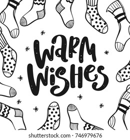 Warm wishes text. Christmas greeting card with brush calligraphy and hand drawn knitted socks.