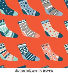 Warm wishes. Winter vector seamless pattern with cute socks on red. Funny doodle socks with different patterns
