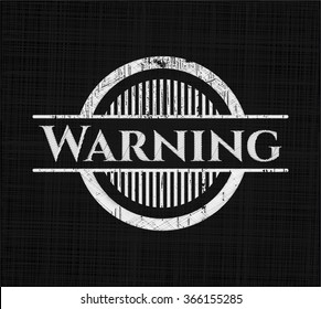 Warning chalk emblem written on a blackboard