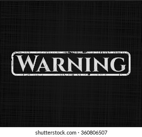 Warning chalkboard emblem written on a blackboard