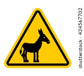 Warning sign attention donkey. Dangers yellow symbol stupid man. Ass on triangle. road signs against idiocy. fool on way caution