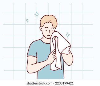 Washing face. Closeup of man cleaning skin with towel. Hand drawn style vector design illustrations.