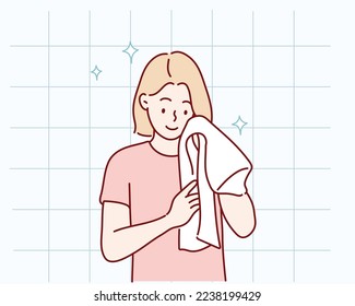 Washing face. Closeup of woman cleaning skin with towel. Hand drawn style vector design illustrations.