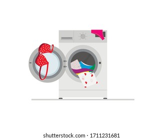 Washing machine. Things are scattered. From the open hatch dropping male underpants.