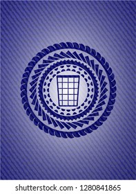 wastepaper basket icon inside badge with denim background