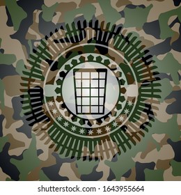 wastepaper basket icon inside camouflage emblem