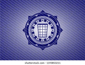 wastepaper basket icon inside emblem with denim texture