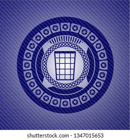 wastepaper basket icon inside emblem with denim texture
