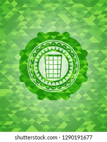 wastepaper basket icon inside green mosaic emblem