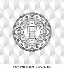 wastepaper basket icon inside grey emblem with geometric cube white background
