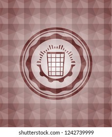 wastepaper basket icon inside red seamless emblem with geometric background.