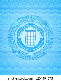 wastepaper basket icon inside sky blue water wave badge.