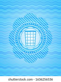 wastepaper basket icon inside sky blue water badge background.