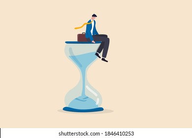 Wasting time waiting and never start new business, time fly or ineffective thinking or laziness concept, depressed businessman sitting on time passing sandglass or hourglass.