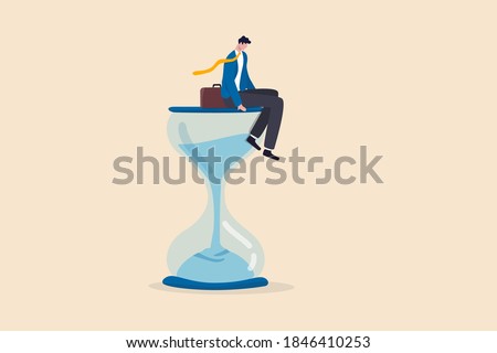 Wasting time waiting and never start new business, time fly or ineffective thinking or laziness concept, depressed businessman sitting on time passing sandglass or hourglass.