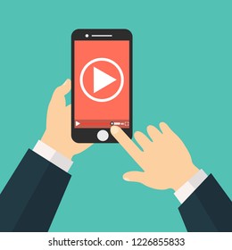 Watch videos on your phone. Mobile phone with video player on the screen. Play online video on your phone.Mobile video streaming technologies.