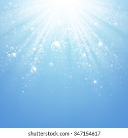 water bubbles in the rays of light on a blue background