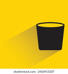water cup with shadow on yellow background