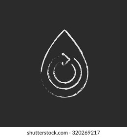 Water drop with circular arrow hand drawn in chalk on a blackboard vector white icon isolated on a black background.