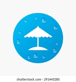 Water drops on button. Beach umbrella sign icon. Protection from the sun. Realistic pure raindrops. Blue circle. Vector