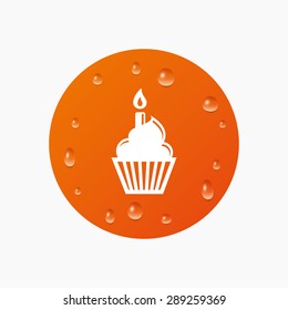 Water drops on button. Birthday cake sign icon. Cupcake with burning candle symbol. Realistic pure raindrops. Orange circle. Vector