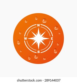 Water drops on button. Compass sign icon. Windrose navigation symbol. Realistic pure raindrops. Orange circle. Vector