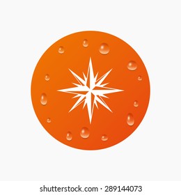 Water drops on button. Compass sign icon. Windrose navigation symbol. Realistic pure raindrops. Orange circle. Vector