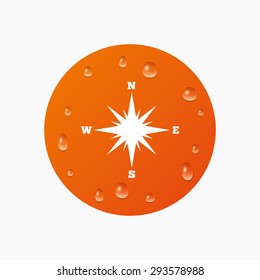 Water drops on button. Compass sign icon. Windrose navigation symbol. Realistic pure raindrops. Orange circle. Vector