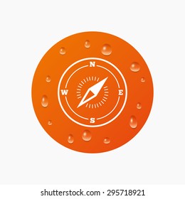 Water drops on button. Compass sign icon. Windrose navigation symbol. Realistic pure raindrops. Orange circle. Vector