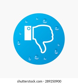 Water drops on button. Dislike sign icon. Thumb down sign. Hand finger down symbol. Realistic pure raindrops. Blue circle. Vector