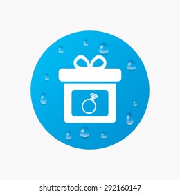 Water drops on button. Gift box sign icon. Present with engagement ring symbol. Realistic pure raindrops. Blue circle. Vector