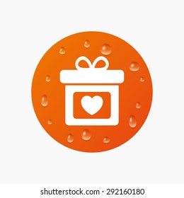 Water drops on button. Gift box sign icon. Present with heart love symbol. Realistic pure raindrops. Orange circle. Vector