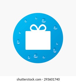 Water drops on button. Gift box sign icon. Present symbol. Realistic pure raindrops. Blue circle. Vector