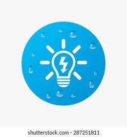 Water drops on button. Light lamp sign icon. Bulb with lightning symbol. Idea symbol. Realistic pure raindrops. Blue circle. Vector
